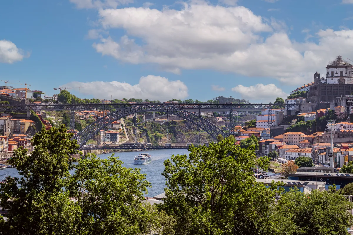 View over the River Douro and the Dom Luís I Bridge in Porto, with the Serra do Pilar Monastery in Gaia