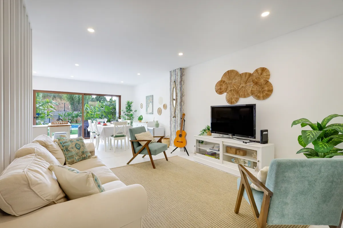 Bright living room opening onto the garden and pool in a short-term rental house managed by BnBird